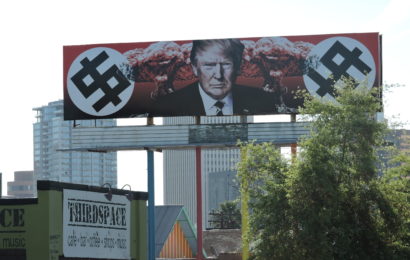 Trump Depicted with Swastika-Like Dollar Signs and Mushroom Clouds on Phoenix Billboard