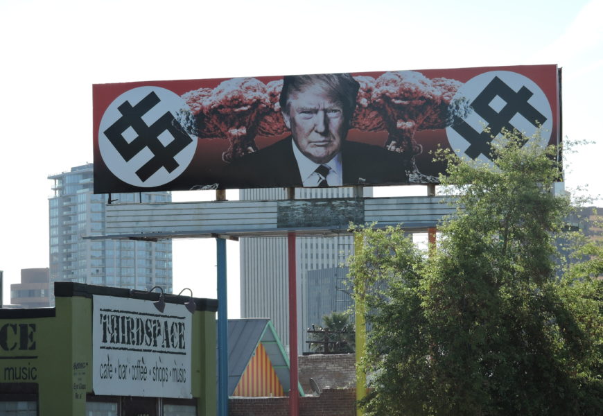 Trump Depicted with Swastika-Like Dollar Signs and Mushroom Clouds on Phoenix Billboard